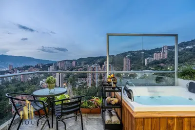 a balcony with a tub and a table and chairs at Urban 2005 - Serenity AC retreat: Soft decoration in El Poblado
