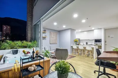 a living room with a kitchen and a dining room at Urban 2005 - Serenity AC retreat: Soft decoration in El Poblado