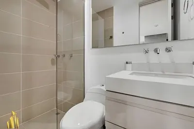 a bathroom with a toilet and a sink and a mirror at Urbano2205-Serenidad y fitness. Apt- piscina/gym in El Poblado