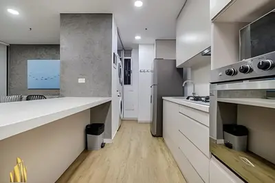 a kitchen with white countertops and a sink at Urbano2205-Serenidad y fitness. Apt- piscina/gym in El Poblado