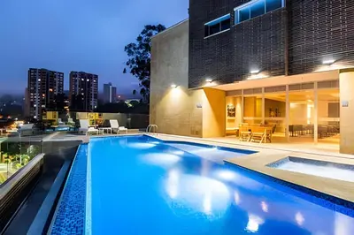 an indoor swimming pool with a view of a building at Urbano2205-Serenidad y fitness. Apt- piscina/gym in El Poblado