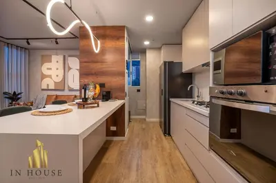 a kitchen with a large white counter top and wooden floors at Urban 2505 - Oasis with pool and gym in El Poblado