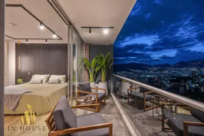a bedroom with a bed and a balcony with a view at Urban 2505 - Oasis with pool and gym in El Poblado