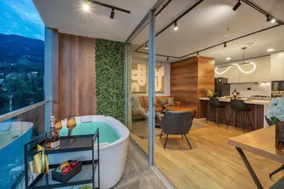a bathroom with a bath tub and a kitchen with a table at Urban 2505 - Oasis with pool and gym in El Poblado