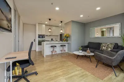 a living room with a couch and a table at Urban 701-Apt relajante con piscina, jacuzzi y gym in El Poblado