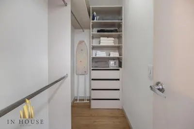 a hallway with white walls and a stairway with a closet at Urban 701-Apt relajante con piscina, jacuzzi y gym in El Poblado