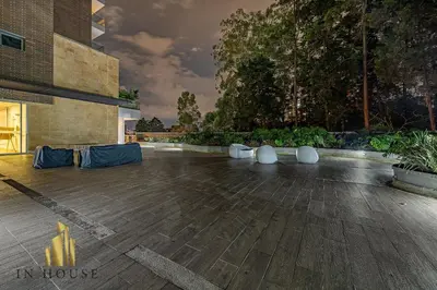 a courtyard with chairs and plants in a building at Urban 701-Apt relajante con piscina, jacuzzi y gym in El Poblado