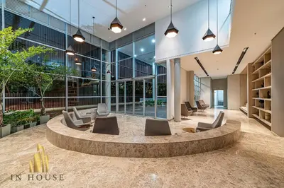 a lobby of a building with chairs and tables at Urban 701-Apt relajante con piscina, jacuzzi y gym in El Poblado
