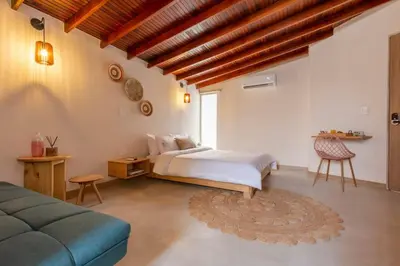 a bedroom with a bed and a couch at Spacious Laureles Apt-SuperHost-AC-WIFI in Medellín