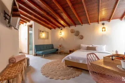 a bedroom with a bed and a blue couch at Spacious Laureles Apt-SuperHost-AC-WIFI in Medellín