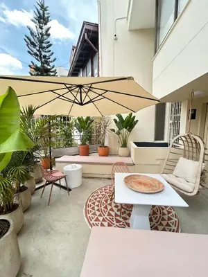 a patio with a table and an umbrella at Spacious Laureles Apt-SuperHost-AC-WIFI in Medellín