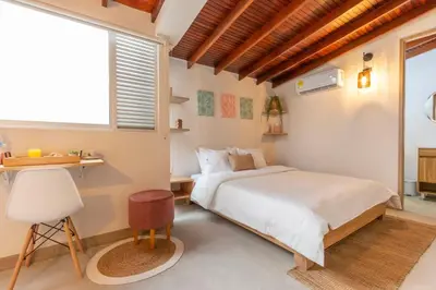 a bedroom with a bed and a desk and a window at Modern Cozy Apt - Laureles -AC - Fast WiFi in Medellín