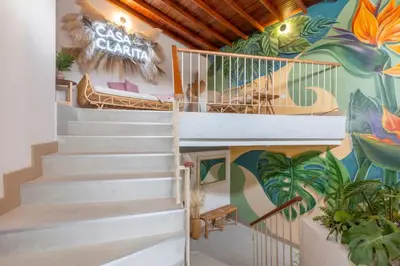 a staircase in a house with a mural at Modern Cozy Apt - Laureles -AC - Fast WiFi in Medellín