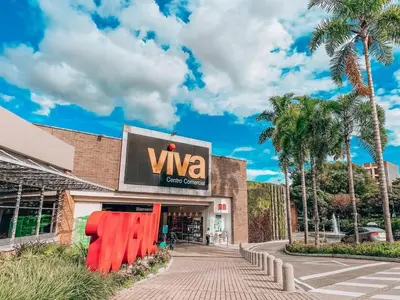 a building with a sign for a viva store at Modern Cozy Apt - Laureles -AC - Fast WiFi in Medellín