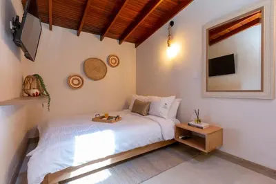 a bedroom with a white bed and a mirror at Laureles Apt-Eco-Smart Locks-AC-Super Location in Medellín