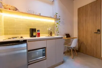 a kitchen with a counter and a sink and a door at Laureles Apt-Eco-Smart Locks-AC-Super Location in Medellín