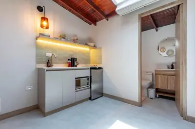 a small kitchen with a sink and a toilet at Spacious Laureles Apt-Smart Lock-Queen Bed-AC in Medellín