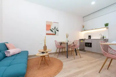 a living room with a blue couch and a table at Spacious Apt -Laureles -AC -Smart Lock- WiFi in Medellín