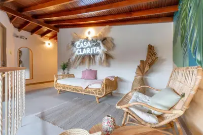 a room with wicker chairs and a sign that reads guest garage at Spacious Apt -Laureles -AC -Smart Lock- WiFi in Medellín
