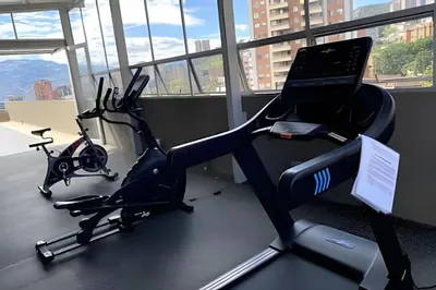 a gym with two exercise bikes and a laptop at Provenza Life 603 - Chic Urban Retreat in El Poblado