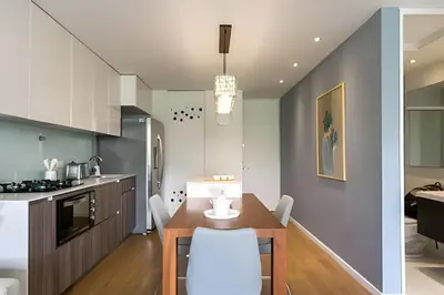 a kitchen with a wooden table and a dining room at Provenza Life 603 - Chic Urban Retreat in El Poblado