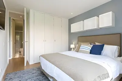 a bedroom with a large bed with blue walls at Provenza Life 603 - Chic Urban Retreat in El Poblado