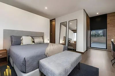 a bedroom with a large bed and a television at C36 apto. 802 - Luminoso Dúplex con Vistas Panorámicas in Medellín