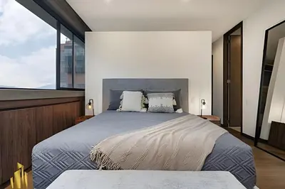 a bedroom with a large bed and a large window at C36 apto. 802 - Luminoso Dúplex con Vistas Panorámicas in Medellín