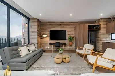 a living room with a couch and a tv at C36 apto. 802 - Luminoso Dúplex con Vistas Panorámicas in Medellín