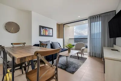a dining room and living room with a table and chairs at Class 48 apto. 1303 - Luminoso / Vistas / Balcón in Sabaneta
