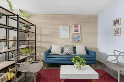 a living room with a blue couch and chairs at Class 48 apto. 1401 - Panorámico para nómadas digital/AC in Sabaneta