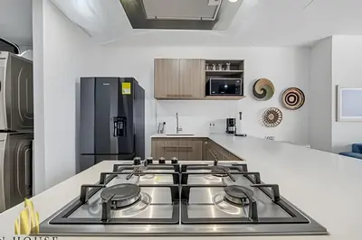 a kitchen with a stove top in a kitchen at Class 48 apto. 1404 - Vistas modernas de la ciudad / AC in Sabaneta