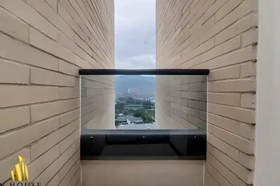 a window in a brick wall with a view at Class 48 apto. 1603 - Sophisticated apt/panoramic views in Sabaneta