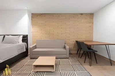 a bedroom with a bed and a desk and a table at Class 48 Apt 2201 - Apt en Sabaneta con balcón privado in Sabaneta