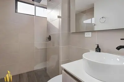 a bathroom with a white sink and a shower at Class 48 Apt. 2202 - Apt luminoso/Balcón/AC in Sabaneta
