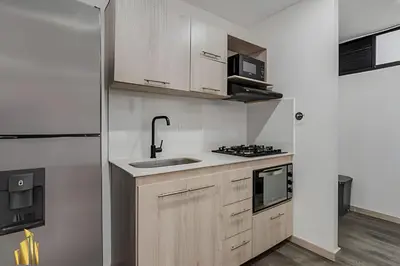 a kitchen with a sink and a stove top oven at Class 48 Apt. 2202 - Apt luminoso/Balcón/AC in Sabaneta