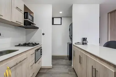 a kitchen with a sink and a stove top oven at Class 48 Apt. 2202 - Apt luminoso/Balcón/AC in Sabaneta