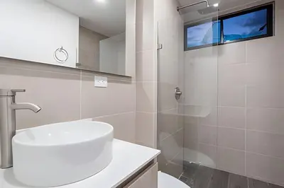 a white bathroom with a sink and a shower at Class 48 Apt. 2301 - Luces de ciudad/Loft/Balcón priv in Sabaneta