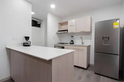 a kitchen with a refrigerator and a counter top at Class 48 Apt. 2301 - Luces de ciudad/Loft/Balcón priv in Sabaneta