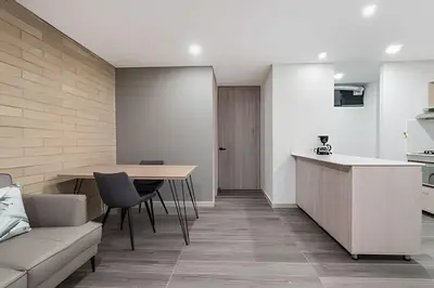 a kitchen and living room with a table and a couch at Class 48 Apt. 2301 - Luces de ciudad/Loft/Balcón priv in Sabaneta