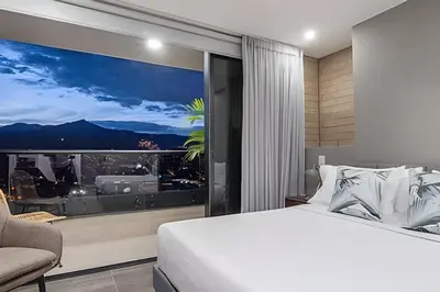 a bedroom with a bed and a large window at Class 48 Apt. 2301 - Luces de ciudad/Loft/Balcón priv in Sabaneta
