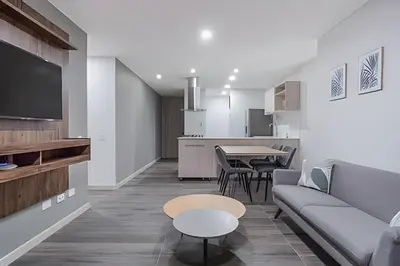 a living room with a couch and a table at Class 48 Apt. 2303 - Loft de alta clase -balcón privado in Sabaneta