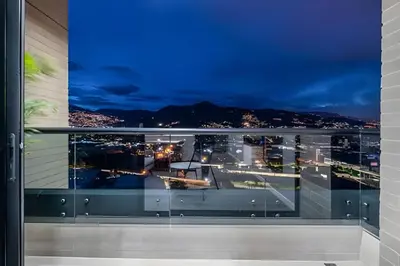 a view of a city from a balcony at night at Class 48 Apt. 2303 - Loft de alta clase -balcón privado in Sabaneta