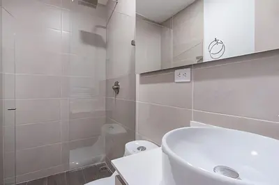 a white bathroom with a sink and a toilet at Class 48 Apt. 2303 - Loft de alta clase -balcón privado in Sabaneta