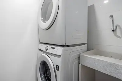 a washer and dryer in a bathroom next to a sink at Class 48 Apt. 2303 - Loft de alta clase -balcón privado in Sabaneta