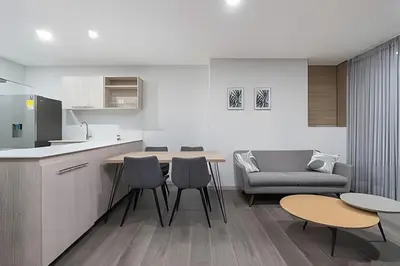a kitchen and living room with a table and chairs at Class 48 Apt. 2303 - Loft de alta clase -balcón privado in Sabaneta