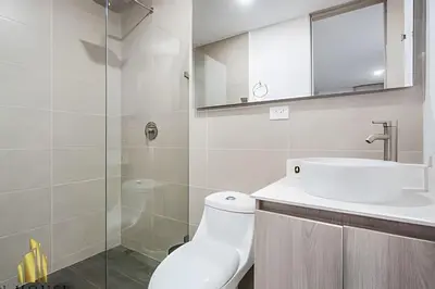 a white bathroom with a sink and a shower at Class 48 Apt. 2304 - Apto con balcón privado/Sabaneta in Sabaneta
