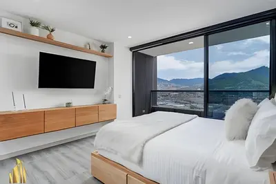 a bedroom with a large bed and a large window at Class 48 Apto. 2501 - Apto tranquilo y luminoso/balcón in Sabaneta