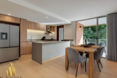 a kitchen and dining room with a table and chairs at La Mannuela 505 - Stylish Living in El Poblado in El Poblado