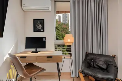 a room with a desk with a computer and a chair at La Mannuela 505 - Stylish Living in El Poblado in El Poblado